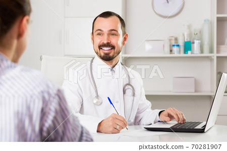 Positive man doctor with female visitor Positive man doctor with female visitor 70281907