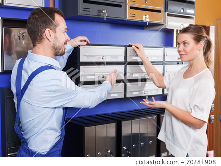 Woman choosing postbox with seller 70281908