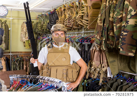 Male customer try on ammunition with rifle Male customer try on ammunition with rifle 70281975