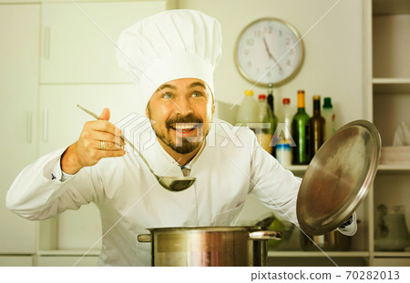 Male cook tasting food 70282013