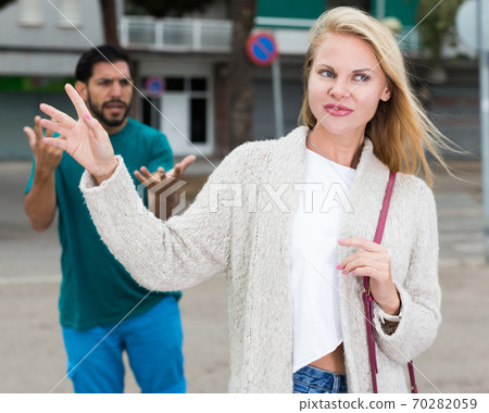 Portrait of female who is angering to adult stranger Portrait of female who is angering to adult stranger 70282059