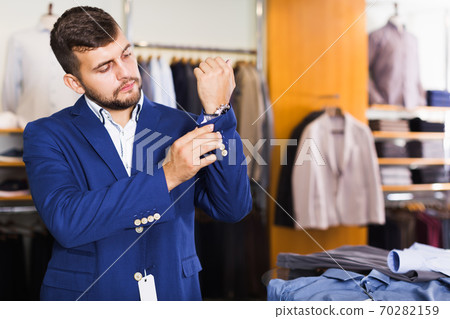 Nice male customer choosing jacket 70282159