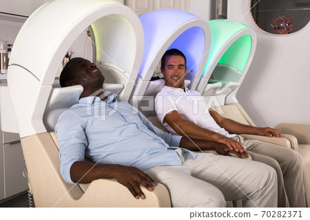 Male clients sitting in armchairs for washing hair Male clients sitting in armchairs for washing hair 70282371