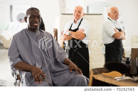 African man approving result of hairdresser work African man approving result of hairdresser work 70282565