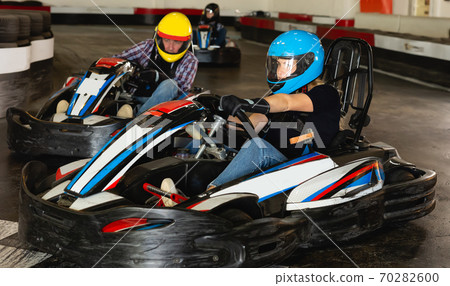 Adult woman driving sport car in a circuit lap Adult woman driving sport car in a circuit lap 70282600