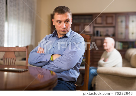 Man and his adult son having conflict Man and his adult son having conflict 70282943
