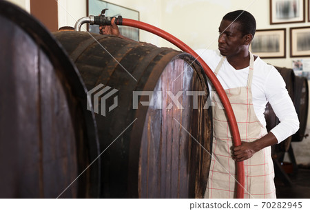 man winegrower working in wine cellar 70282945