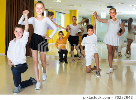 Smiling kids are dancing waltz 70282948
