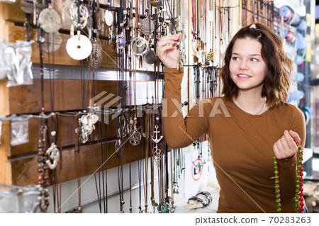 Woman showing different pendant Woman showing different pendant 70283263