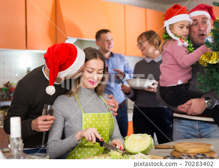 Family preparing for Christmas dinner Family preparing for Christmas dinner 70283402