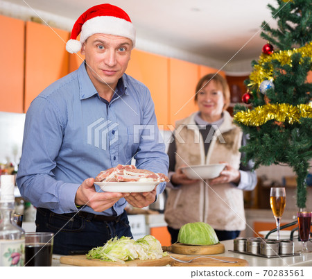 Man cooking for christmas table 70283561