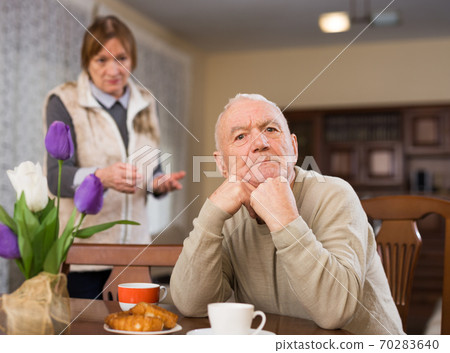 Frustrated aged man with woman rebuking him 70283640