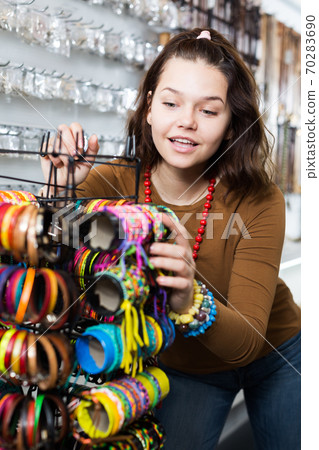 Female showing different bracelets Female showing different bracelets 70283690