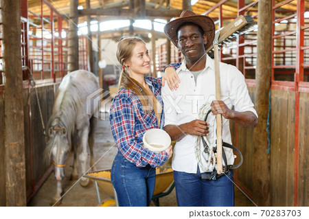 Portrait of couple of horse farm workers 70283703
