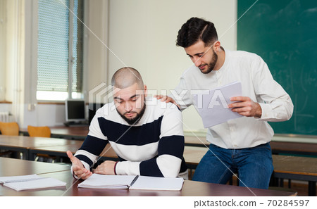 Student helping his worried friend Student helping his worried friend 70284597