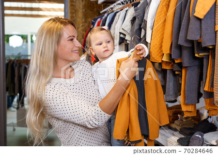 Woman and daughter shopping in clothing store Woman and daughter shopping in clothing store 70284646