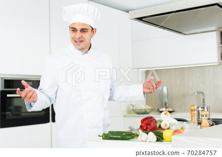 Professional man chef searching ingredients, preparing vegetables 70284757