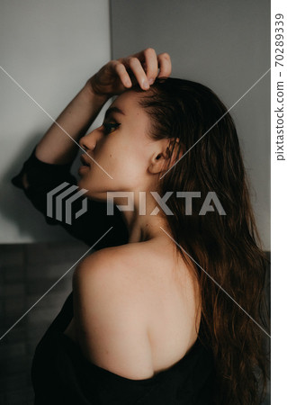 Closeup female portrait. Fashion evening elegance eyeliner makeup on model eyes. Make-up with black eyeliner 70289339