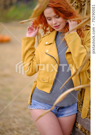 Autumn portrait of a beautiful woman with pumpkins Autumn portrait of a beautiful woman with pumpkins 70290081