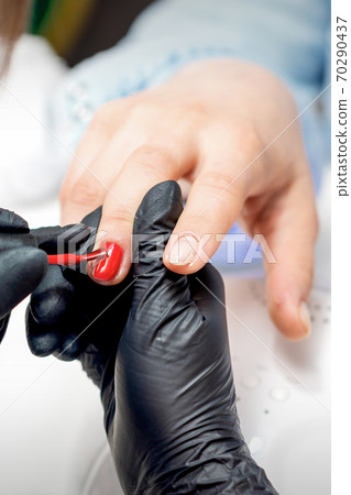 Manicure master painting female nails Manicure master painting female nails 70290437