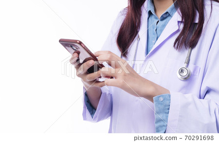 Hand of young woman doctor wear uniform with stethoscope using or texting on smartphone  70291698