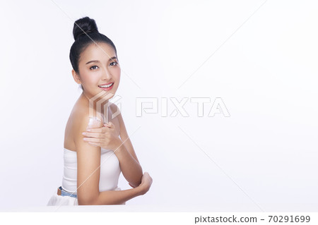 Portrait of smile young woman holding applying cosmetic cream or treatment moisturize in her body  70291699