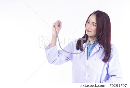Cheerful young woman doctor in uniform holding stethoscope isolated 70291797