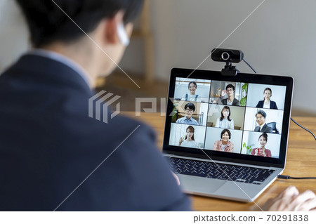 Image of the back of a man having an online meeting 70291838