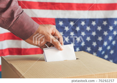 Close up of man's hand putting card in box with slot, 70292257