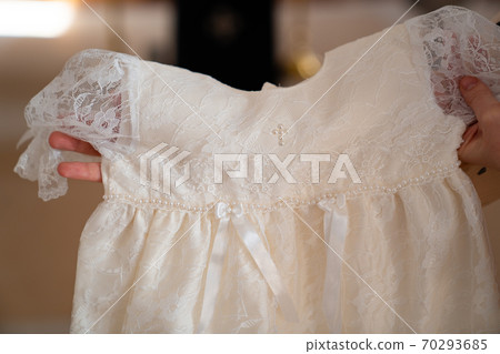 white dress for baptism in Orthodox Church. 70293685