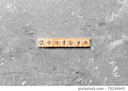 Goodbye word written on wood block. Goodbye text on table, concept 70294945