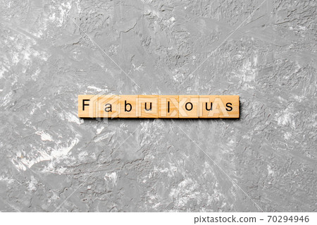 Fabulous word written on wood block. Fabulous text on cement table for your desing, concept 70294946