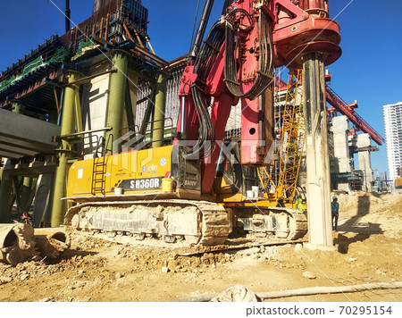 KUALA LUMPUR, MALAYSIA -MARCH 30, 2020: Bore pile rig machine at the construction site. The machine used to driven pile for building foundation work. Operated by skilled workers. KUALA LUMPUR, MALAYSIA -MARCH 30, 2020: Bore pile rig machine at the construction site. The machine used to driven pile for building foundation work. Operated by skilled workers. 70295154