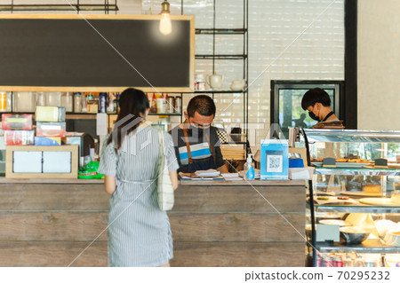 Social distance conceptual small business waiter serving customer in cafe. 70295232