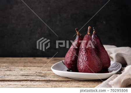 Poached pears in red wine 70295806