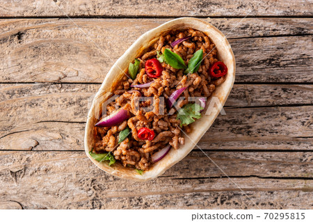 Mexican barquita taco on wooden table Mexican barquita taco on wooden table 70295815