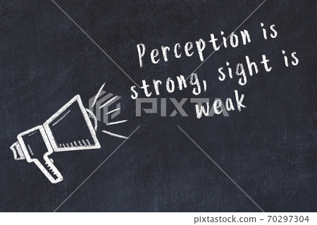 Chalk loudspeaker and wise quote on black desk 70297304