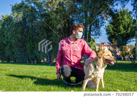 boy wearing virus mask with his dog playing at garden boy wearing virus mask with his dog playing at garden 70298057