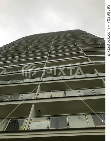a beautiful tall white residential building 70298595