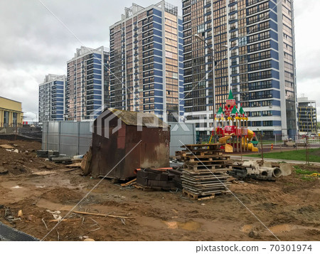 a small rusty garage stands in the center of a new 70301974