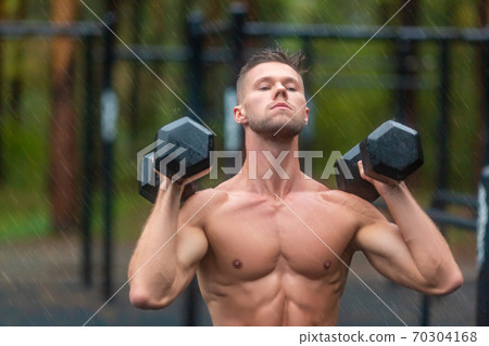 Close up portrait of a sportsman during hard workout outdoor in a rainy day. 70304168