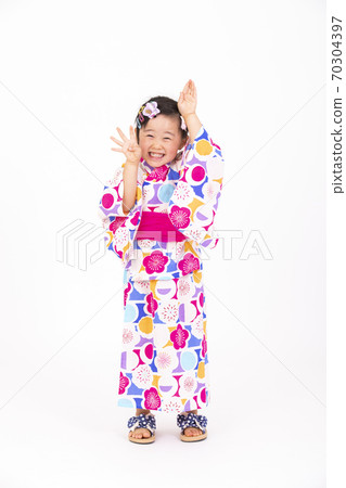 A 4-year-old girl wearing a yukata and making various poses A 4-year-old girl wearing a yukata and making various poses 70304397