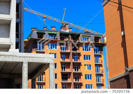 Building crane and house under construction 70305736