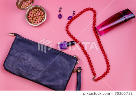 Clutch bag, red necklace, earrings, nail polish, rouge balls and bottle of perfume on pink background. Beauty and fashion concept. Flat lay, top view Clutch bag, red necklace, earrings, nail polish, rouge balls and bottle of perfume on pink background. Beauty and fashion concept. Flat lay, top view 70305751