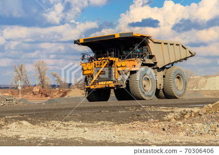 Huge yellow mining dump truck working in iron ore quarry. Mining industry 70306406