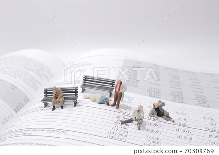 a social theme. Hungry homeless figure men on the book 70309769