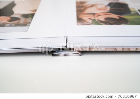 photo book binding. storing photo in photobook. 70310967