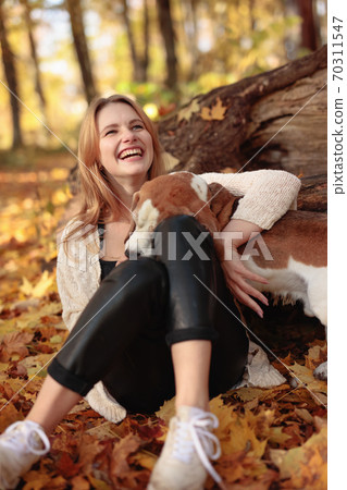 Beautiful girl with dog in park. Beautiful girl with dog in park. 70311547