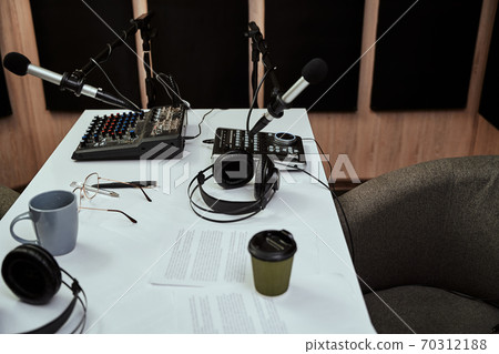 Working place of radio host. Close up of microphones, headphones, sound mixing desk, script on the table in recording studio or broadcast room 70312188