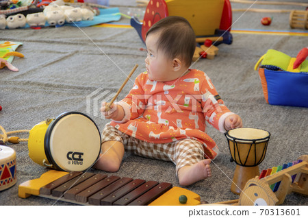 Toddlers playing with old-fashioned toys 70313601